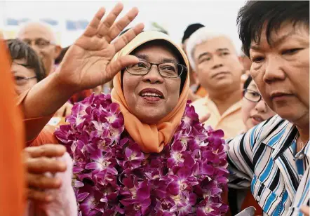  ?? — AP ?? Momentous coup: Halimah surrounded by supporters after she was named Singapore’s eighth president without a vote.