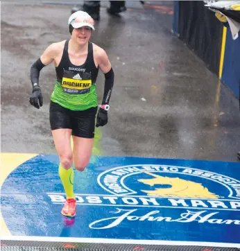  ?? RYAN MCBRIDE/AFP/GETTY IMAGES ?? Krista DuChene of Strathroy, Ont., crossed the finish line in a time of two hours, 44 minutes and 20 seconds, good for third place in Monday’s running of the 122nd Boston Marathon.