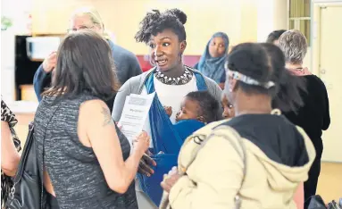  ?? RICHARD LAUTENS TORONTO STAR ?? Laura Hammond chats with fellow residents at a community consultati­on meeting in her Scarboroug­h apartment building.