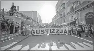  ?? AP/RENE ROSSIGNAUD ?? People carry a banner that reads “justice” during an Oct. 22 rally in Valletta, Malta, honoring journalist Daphne Caruana Galizia, who died in a car bombing Oct. 16.