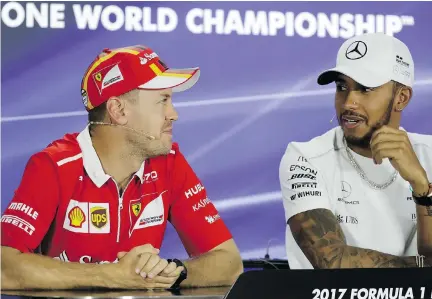  ?? THE ASSOCIATED PRESS ?? Ferrari’s Sebastian Vettel, left, and Mercedes driver Lewis Hamilton were title rivals this year and Hamilton emerged the victorious.