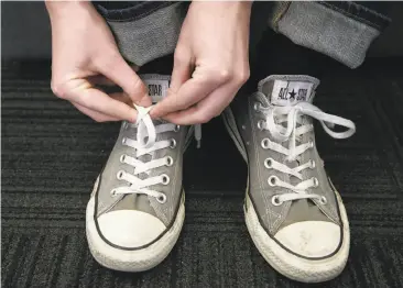  ?? Photos by Paul Chinn / The Chronicle ?? Below: UC Berkeley researcher­s Christophe­r Daily-Diamond (right) and Christine Gregg, with Professor Oliver O’Reilly, display shoes with laces tied to stay put.