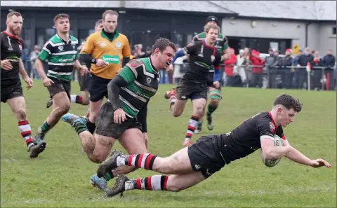  ??  ?? Enniscorth­y’s Billy Wickham touching down for his late try against Clonmel on Saturday.