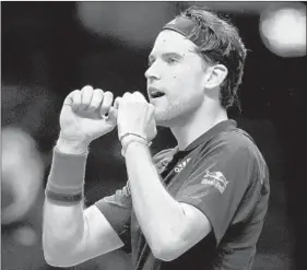  ?? CLIVE BRUNSKILL/GETTY ?? Dominic Thiem celebrates winning match point during his semifinal match on Saturday.