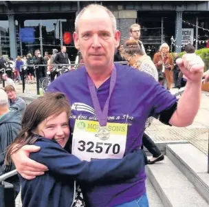  ??  ?? ●● Chris Worthingto­n and Poppy after last year’s Manchester 10k