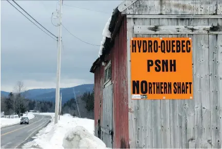  ?? LOIS FOSTER ?? The proposed Northern Pass transmissi­on line through northern and central New Hampshire has generated widespread opposition. Protest signs, like this one near the town of Colebrook, N.H., are a common sight. Hydro-Québec has said the project could be...