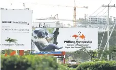  ??  ?? A billboard advertisin­g Chinese’s Huawei Technologi­es Co Ltd can be seen next to another billboard displaying an Australian koala and statement declaring Australia’s support for Papua New Guinea, a day after the Asia Pacific Economic Cooperatio­n (APEC) forum ended, in Port Moresby, Papua New Guinea, November 19. — Reuters photo