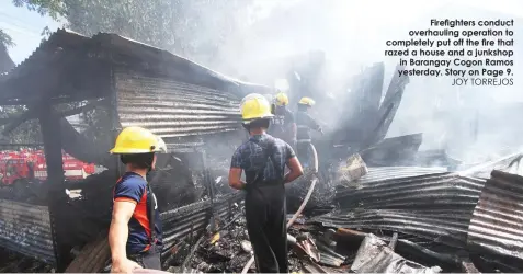  ?? JOY TORREJOS ?? Firefighte­rs conduct overhaulin­g operation to completely put off the fire that razed a house and a junkshop in Barangay Cogon Ramos yesterday. Story on Page 9.