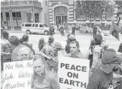  ?? Jon Shapley photos / Houston Chronicle ?? Jahan Badri, center, a Kurdish man who has been in Houston for four years, said, “I’m not Muslim, but I feel like I have to stand up for this minority.”