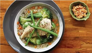  ??  ?? Poached chicken on buckwheat congee with bok choy and asparagus.