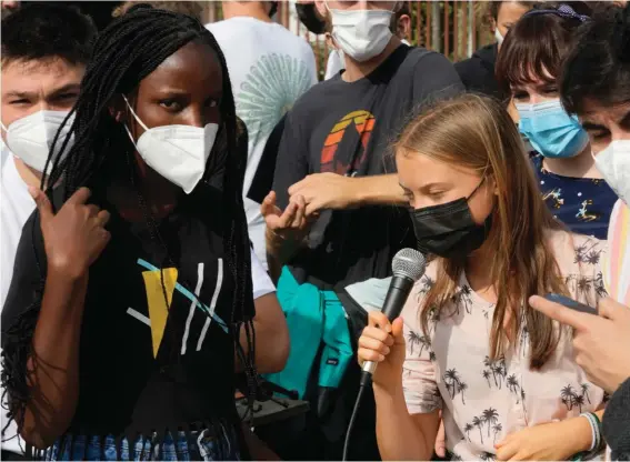  ?? Youth for ?? Ugandan climate activist Vanessa Nakate, left, and Swedish activist Greta Thunberg talk during the final day of a three-day Climate summit in Milan, Italy yesterday. Photo: AP