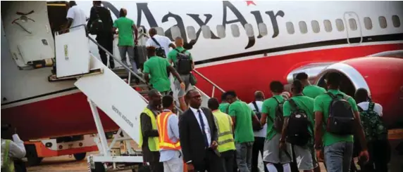  ??  ?? Super Eagles players and officials boarding the first internatio­nal flight out of the Asaba Airport …yesterday evening
