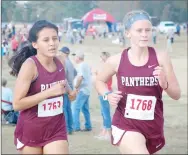  ??  ?? Siloam Springs sophomores Claudia Mercado, left, and Rebekah Rodgers run side by side Friday at the Class 6A state cross country meet at Oaklawn Park in Hot Springs. Mercado finished 34th with a time of 23:07.7, while Rodgers was 21st at 22:09.2.