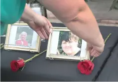  ?? — AFP photo ?? Pictures of victims of the Santa Fe High School shooting are displayed during a prayer vigil at Walter Hall Park in League City, Texas.