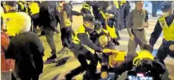  ?? —REUTERS ?? GRABBED Police detain people during a protest against COVID curbs in Shanghai as shown in this screengrab from a video released on Nov. 27.