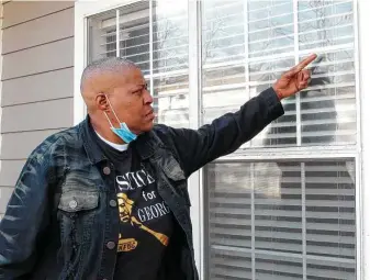  ?? Juan A. Lozano / Associated Press ?? LaTonya Floyd, the older sister of George Floyd, gestures toward a bullet hole in the window of her apartment after a New Year’s Day shooting that wounded her and 4-year-old Arianna Delane.