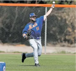 ?? JOHN BAZEMORE/THE ASSOCIATED PRESS ?? New York Mets outfielder Tim Tebow works Monday during a spring training baseball practice in Port St. Lucie, Fla.