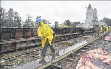  ?? HYOSUB SHIN / HSHIN@AJC.COM ?? Workers build concrete box beams at Standard Concrete Products’ Atlanta location on Tuesday. Behind the rapid repair of the I-85 bridge was a subcontrac­tor in west Atlanta that made incredibly heavy girders — and produced them at a record pace to get...