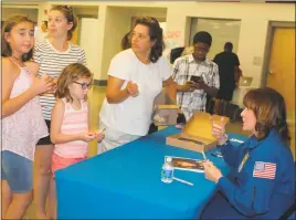  ?? STAFF PHOTOS BY JAMIE ANFENSON-COMEAU ?? NASA astronaut Anna Fisher signs autographs during the “Space in the Community” event at the James E. Richmond Science Center Wednesday night.