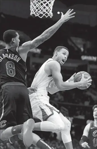  ?? KEN BLAZE / USA TODAY SPORTS ?? Golden State Warriors' Stephen Curry drives to the basket against Cleveland Cavaliers' Jordan Clarkson in the second half of Wednesday’s NBA game in Cleveland. Curry had 42 points to lead the Warriors to a 129-105 victory.