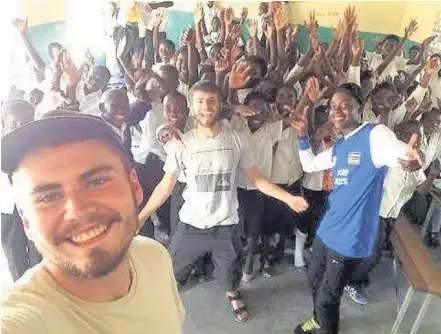  ??  ?? Dylan, front, with students during a sexual health session in a local school in Zambia