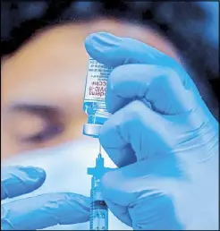  ?? AFP ?? Medical worker Robert Gilberson loads a syringe with Moderna’s COVID-19 vaccine to be administer­ed by nurses at Kedren Community Health Center in South Central Los Angeles, California in this Feb. 16 file photo.