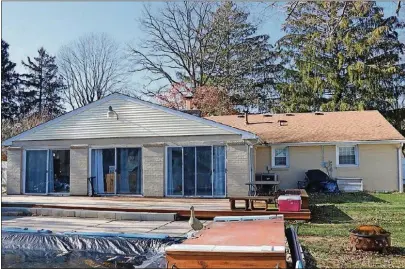  ??  ?? A sun room has ceramictil­e flooring and several patio doors that open to the private backyard, which has an inground swimming pool, 13-by-30foot deck, storage shed and is surrounded by a white vinyl fence.