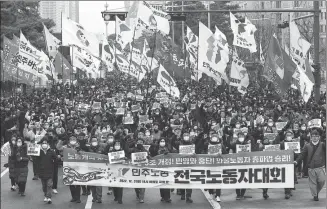  ?? YONHAP / VIA REUTERS ?? South Korean workers from the country’s biggest labor union march during a rally in support of the strike by truckers near the National Assembly in Seoul on Saturday.