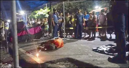  ??  ?? Police officers keep onlookers away from the body of former barangay watchman Ronnie Borbon Gimoro, who was shot during a birthday celebratio­n along West Zamora street in Pandacan, Manila on Wednesday night. Photo courtesy of Maricris Arellano.