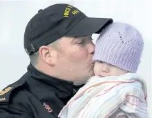  ?? ANDREW VAUGHAN/THE CANADIAN PRESS ?? Petty Officer (second class) Paul Haynes kisses his eight-month-old daughter Brooke before boarding HMCS St. John’s, which is heading to the Mediterran­ean Sea for a deployment with NATO forces, in Halifax on Tuesday.