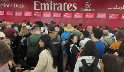  ?? ?? People queue at a flight connection desk after a rainstorm hit Dubai, causing delays at the Dubai Internatio­nal Airport on April 17, 2024. — reuters file