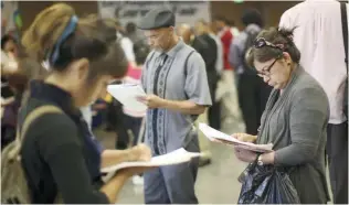  ?? — Reuters ?? US job seekers fill out applicatio­ns during the 11th annual Skid Row Career Fair the Los Angeles Mission in Los Angeles, California.