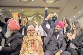  ?? AP PHOTO ?? Jagmeet Singh flanked by his mother Harmeet Kaur and father Jagtaran Singh (left) and campaign manager Michal Hay (right) as it's announced he has won the first ballot in the contest for leader of the leftist New Democratic Party in Toronto.