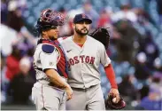  ?? Elaine Thompson / Associated Press ?? Catcher Christian Vazquez and pitcher Martin Perez celebrate Boston’s victory in Seattle.