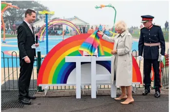  ??  ?? Camilla meets a Star Wars stormtroop­er wearing a kilt (left) as she opens Team Hamish Splashpad in Nairn ( also below). She and Prince Charles had earlier
unveiled a giant patchwork blanket installati­on at Dumfries House (above)