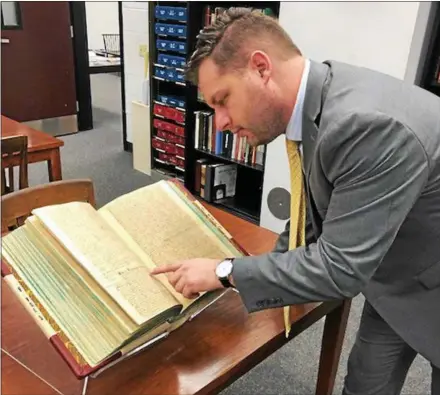  ?? SUBMITTED PHOTOS ?? Pictured is Chester County Recorder of Deeds Rick Loughery looking at the deed book.