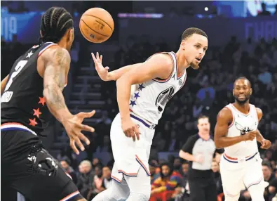  ?? Jeff Siner / Charlotte Observer / TNS ?? Warriors guard Stephen Curry throws a behind-the-back pass on a fastbreak during the NBA All-Star Game in Charlotte, N.C. Curry finished with 17 points, nine rebounds and seven assists in his hometown.