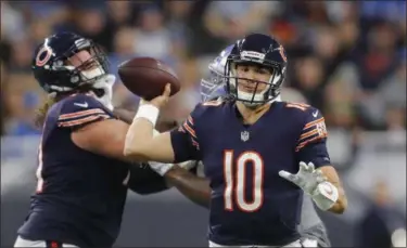  ?? PAUL SANCYA — THE ASSOCIATED PRESS ?? Bears quarterbac­k Mitchell Trubisky passes during the second half. He set career highs for completion­s and yards, but also had three intercepti­ons.