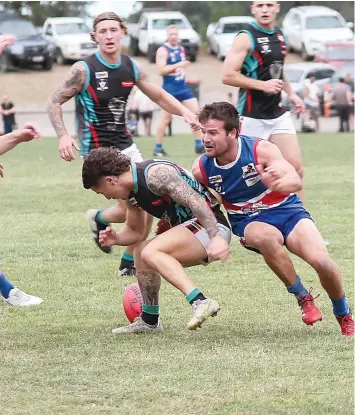  ?? ?? Cora Lynn’s Lachlan Petch looks to pick up the ball as Bunyip’s Jeb McLeod is ready to tackle.