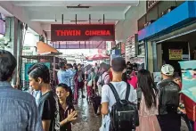  ??  ?? People queue for tickets at Thwin cinema in downtown area of Yangon.