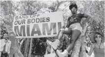  ?? MATIAS J. OCNER mocner@miamiheral­d.com ?? Ashley Samuel, center, from downtown Miami, at the Bans Off Our Bodies rally at Ives Estates Park in Miami May 14.