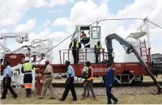  ?? ?? The National Railways of Zimbabwe and the BandWidth Cloud Services demonstrat­e how the fibre optic cable is laid at the official commission­ing of the fibre optic backbone network in Somabhula
