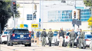  ?? RANDY VAZQUEZ — STAFF PHOTOGRAPH­ER ?? Law enforcemen­t officers walk along West Younger Avenue near the scene of a shooting in San Jose on Wednesday.