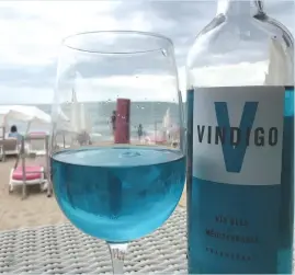  ?? REUTERS ?? A GLASS of Vindigo, Mediterran­ean chardonnay wine, is seen at a beachfront restaurant in Sete, France, Aug. 9. The wine is filtered through a pulp of red grape skins which contain a natural pigment, anthocyani­n, and gives the wine its blue color.