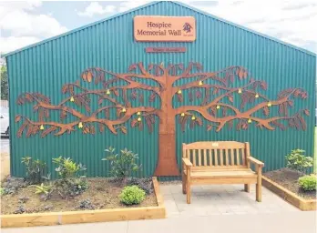  ??  ?? The new memorial wall at Mid-North Hospice in Kerikeri Road. The macrocarpa bench seat in front honours a former colleague who passed away in 2019.