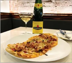  ?? COURTESY OF GRAND TOUR
— symbolized by ?? Le Grand Depart menu at Boston’s Grand Tour features a ‘stop’ in Alsace this tarte flambee.