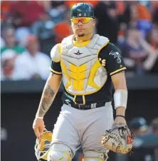  ?? G Fiume / Getty Images 2017 ?? A’s catcher Bruce Maxwell had a rough start to spring training, exiting the game after being hit by Jefry Marte’s backswing.