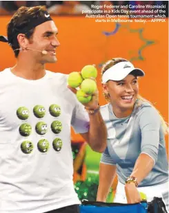  ??  ?? Roger Federer and Caroline Wozniacki participat­e in a Kids Day event ahead of the Australian Open tennis tournament which starts in Melbourne today. – AFPPIX