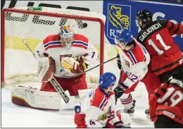  ?? CP PHOTO / GEOFF ROBINS ?? Canada's Jonah Gadjovich puts the puck past Czech Republic goalie Jakub Skarek during the third period in their World Junior Championsh­ips pre-tournament game in London Ont. on Wednesday.