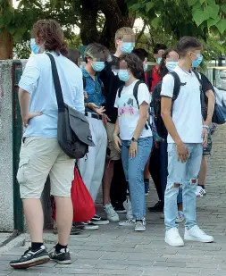  ??  ?? Con le mascherine Ragazzi davanti alla scuola con le protezioni